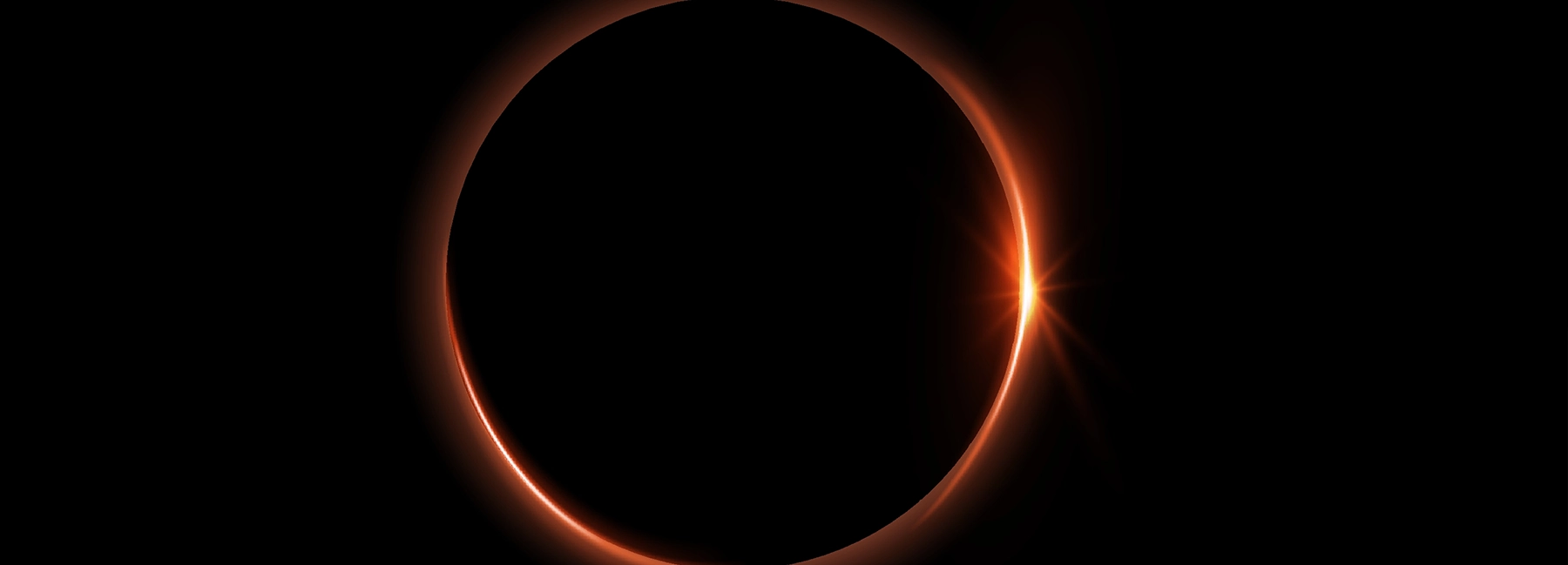 Solar Eclipse captured with the sun peeking out behind the moon on the right hand side.
