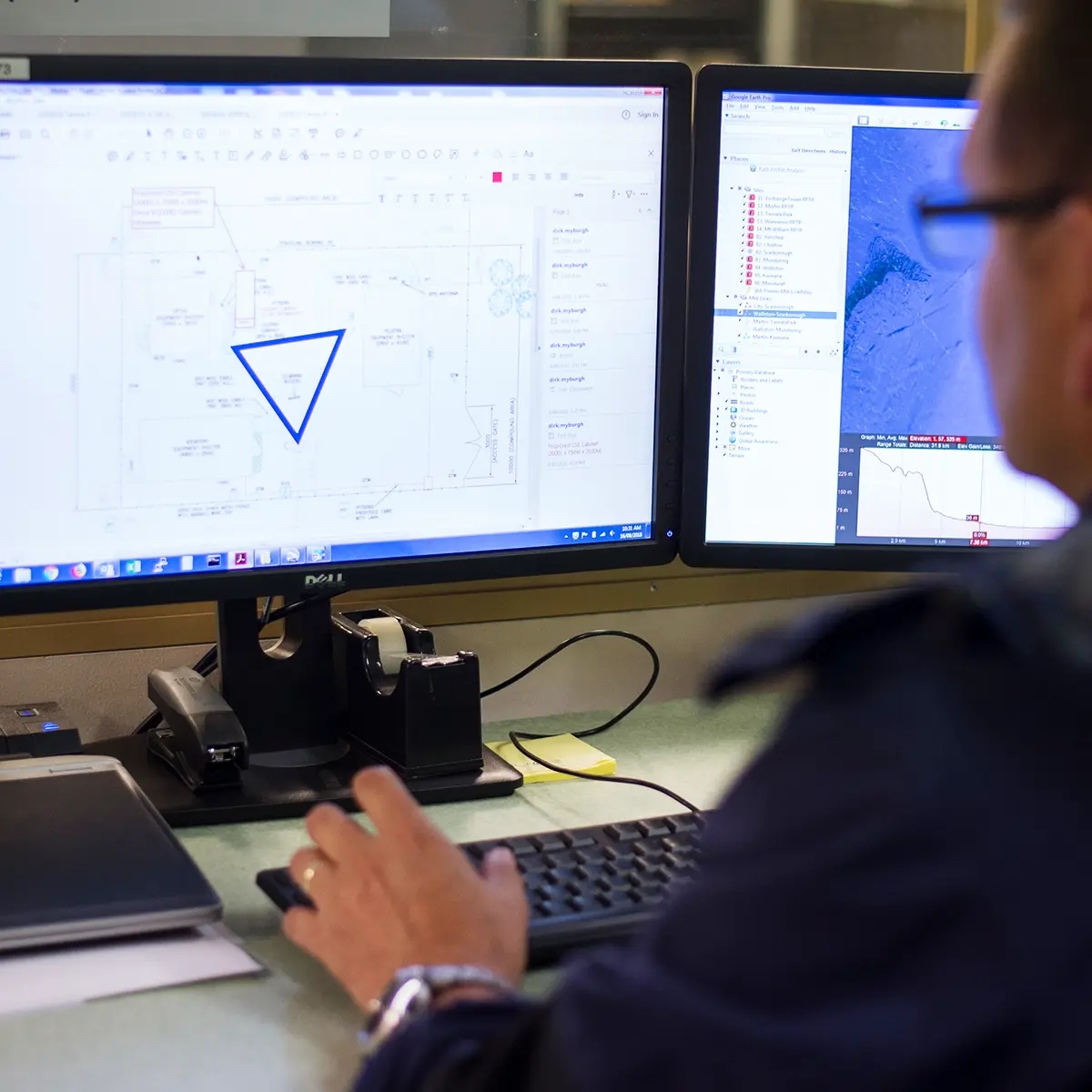 Desk setup with tracking software and data charts on screen, illustrating CSE Crosscom’s fleet management and telemetry solutions.