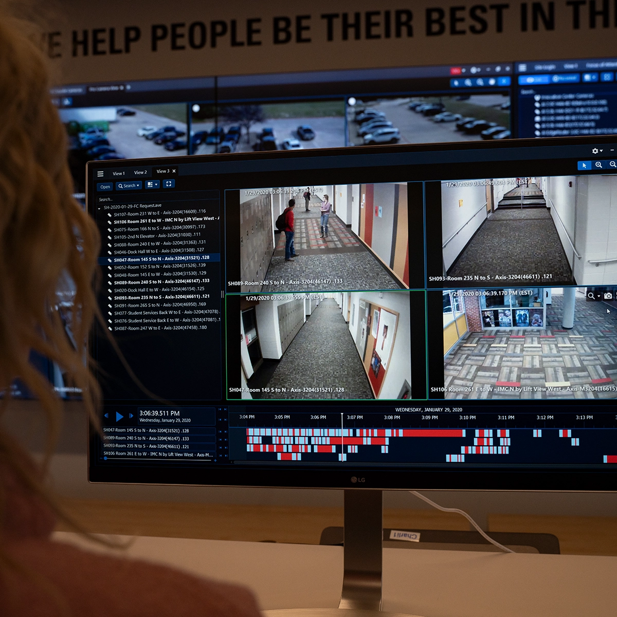 Security operator reviewing multiple camera feeds and activity logs using Avigilon video management software.