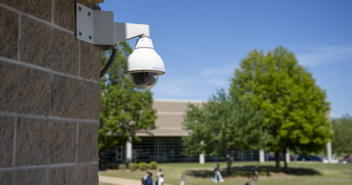 Motorola Solutions Avigilon security camera watches over students walking around a busy University Campus.