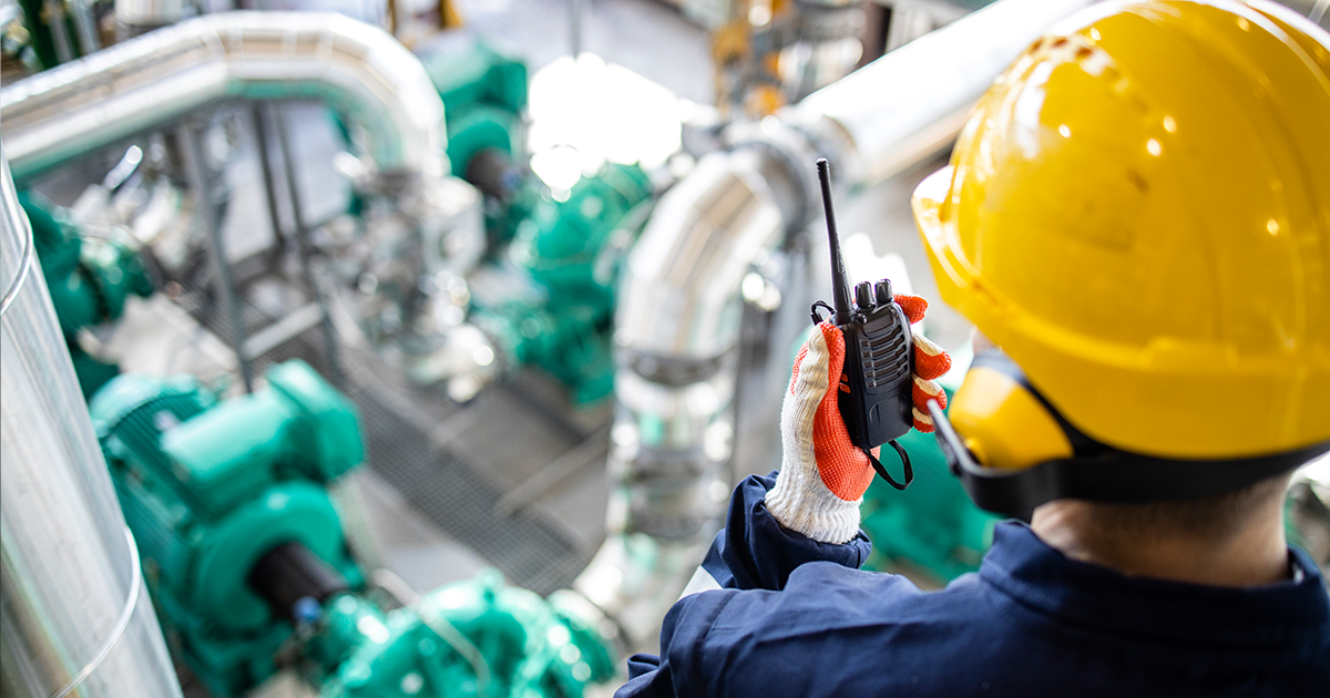 Utilities operator uses a two-way radio connected to the Orion Network to relay critical communication across a vast plant.