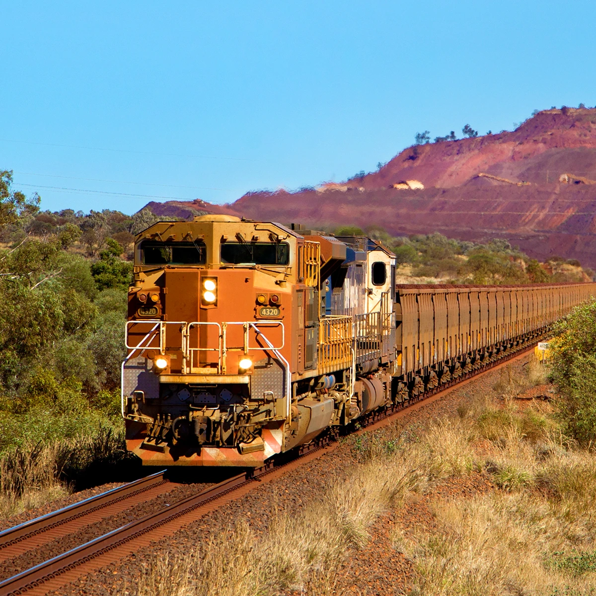 Mining freight train transporting ore through remote terrain, supported by Eventide recording solutions from CSE Crosscom for safety compliance and operational review.