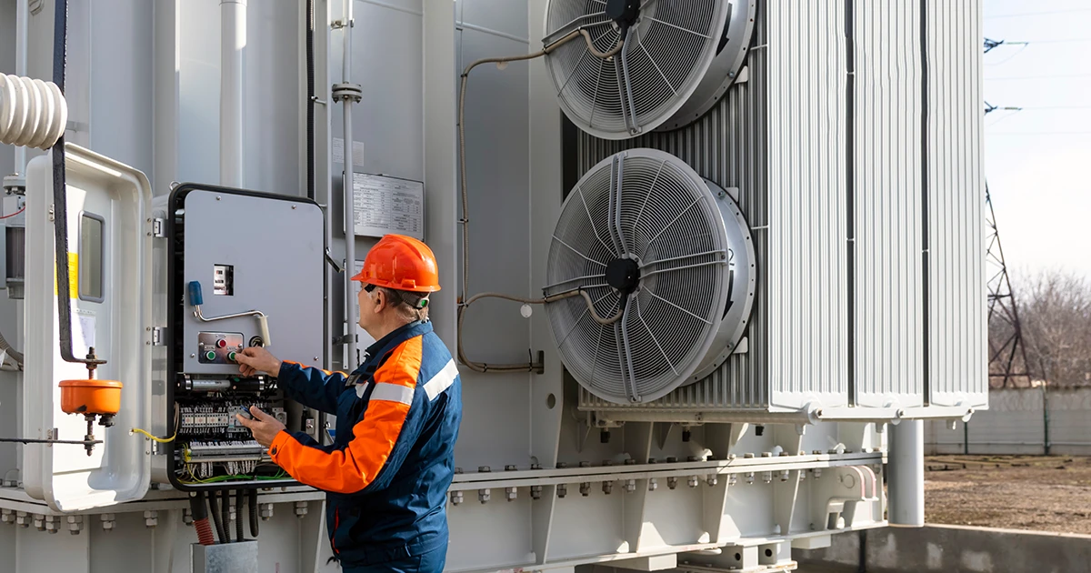 Utility technician inspecting electrical transformer control panel for condition monitoring, supported by CSE Crosscom IoT and LoRaWAN connectivity solutions.