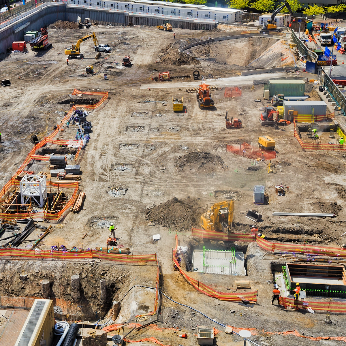 Construction workers at a vast, distributed build site use two-way radios connected with the Orion Network to communicate