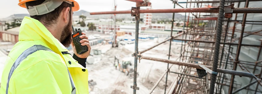Construction Worker using Motorola Two-way Radio