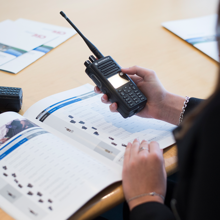 A CSE Crosscom team member performs maintenance on a two-way radio solution.