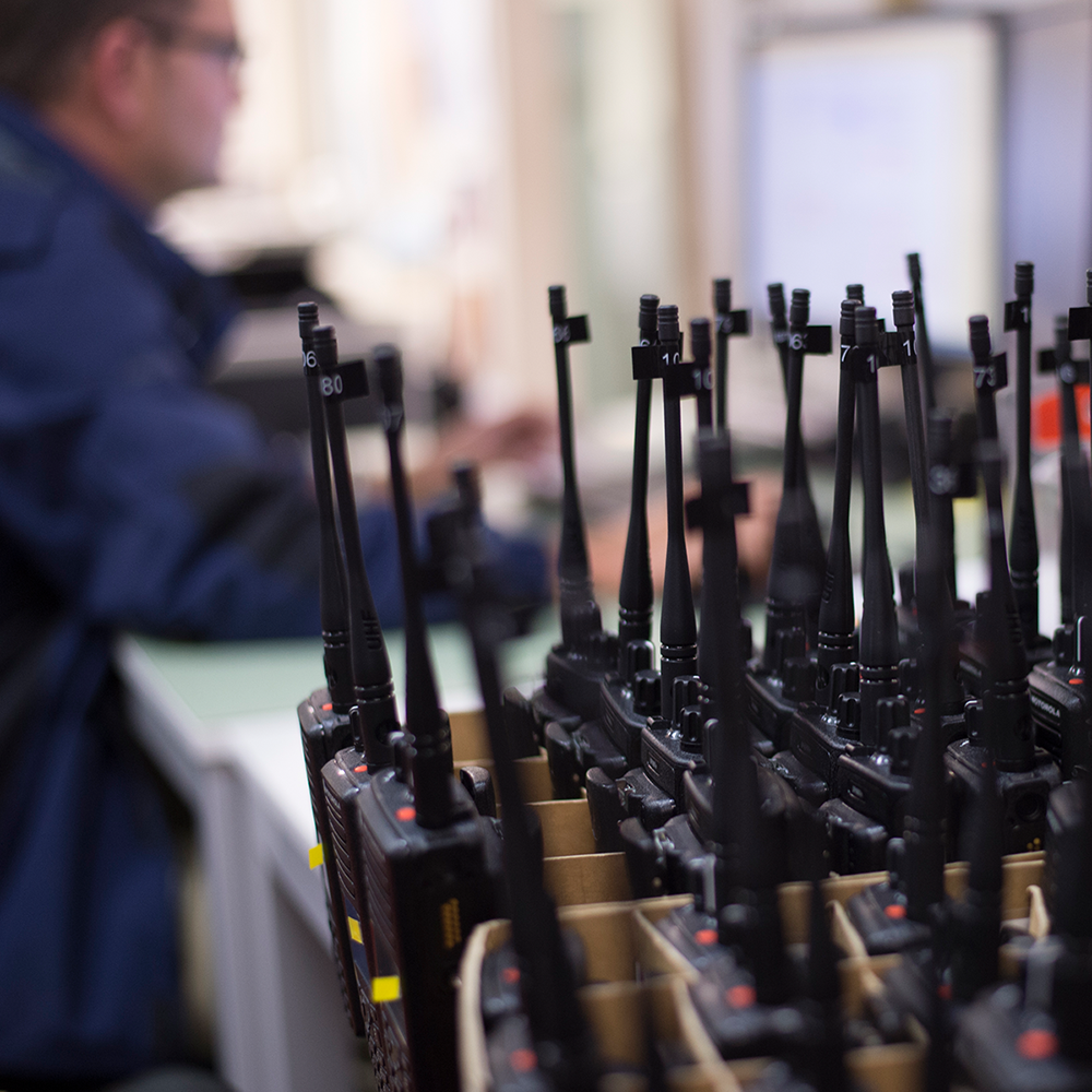 Two Way radios site in a warehouse ready to be programmed.