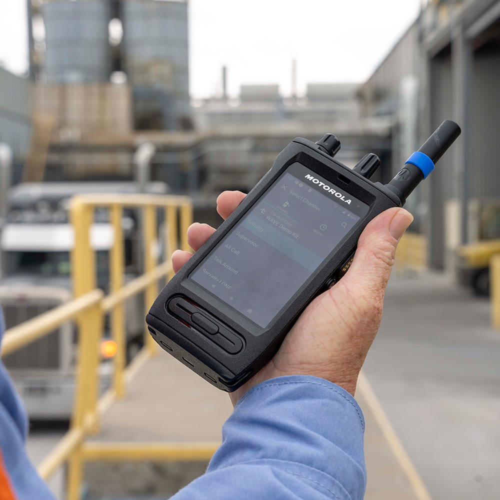 Manufacturing employee uses Push to Talk connectivity on a Motorola Solutions ION 8743 two-way radio to contact security.