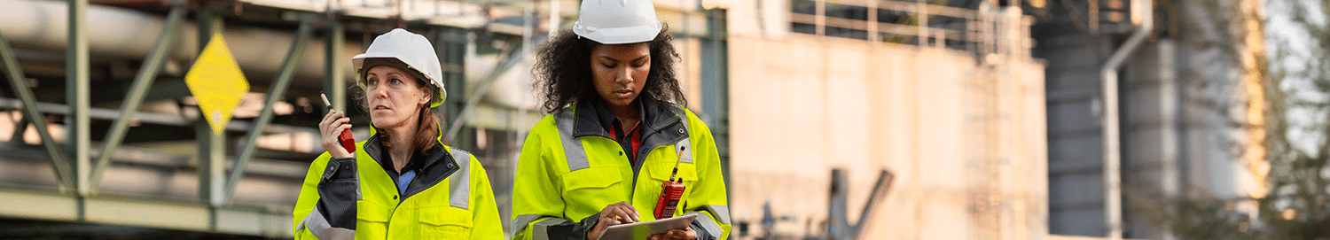 Two CSE Crosscom technicians use two-way radios connected via a point-to-point system.