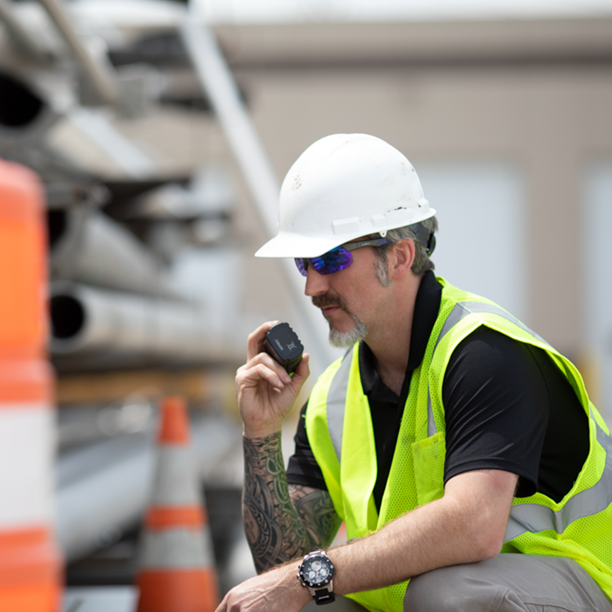 Construction worker uses a Motorola Solution's Two-Way Radio to relay critical information on an Australian construction site.